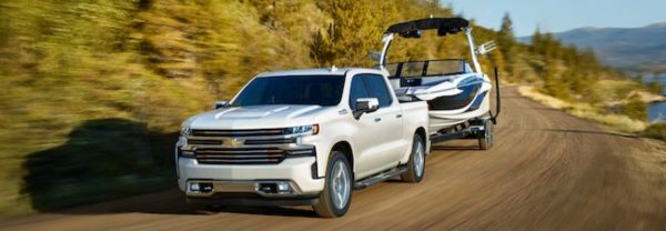 2019 Chevrolet Silverado 1500 pulling a boat down the road